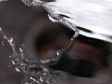 Breakup of a moving sheet of water bouncing off of a spoon.