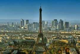 The Eiffel Tower (foreground) and the skyscrapers of the La Défense business district (background).