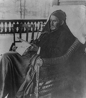 Grant is reclining in a chair on a porch suffering from throat cancer and writing his memoirs.