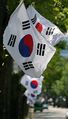 A series of South Korean flags flying on street