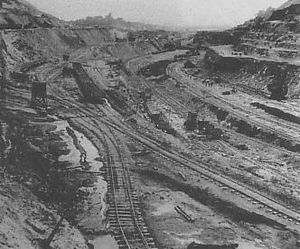 Image showing an excavation being cut into hills with crisscrossed railway tracks.
