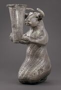 Kneeling Bull with Vessel. Kneeling bull holding a spouted vessel, Proto-Elamite period (3100-2900 BC). Metropolitan Museum of Art[10]
