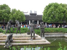 Riverside sculptures with the characters "Wuzhen" in the background